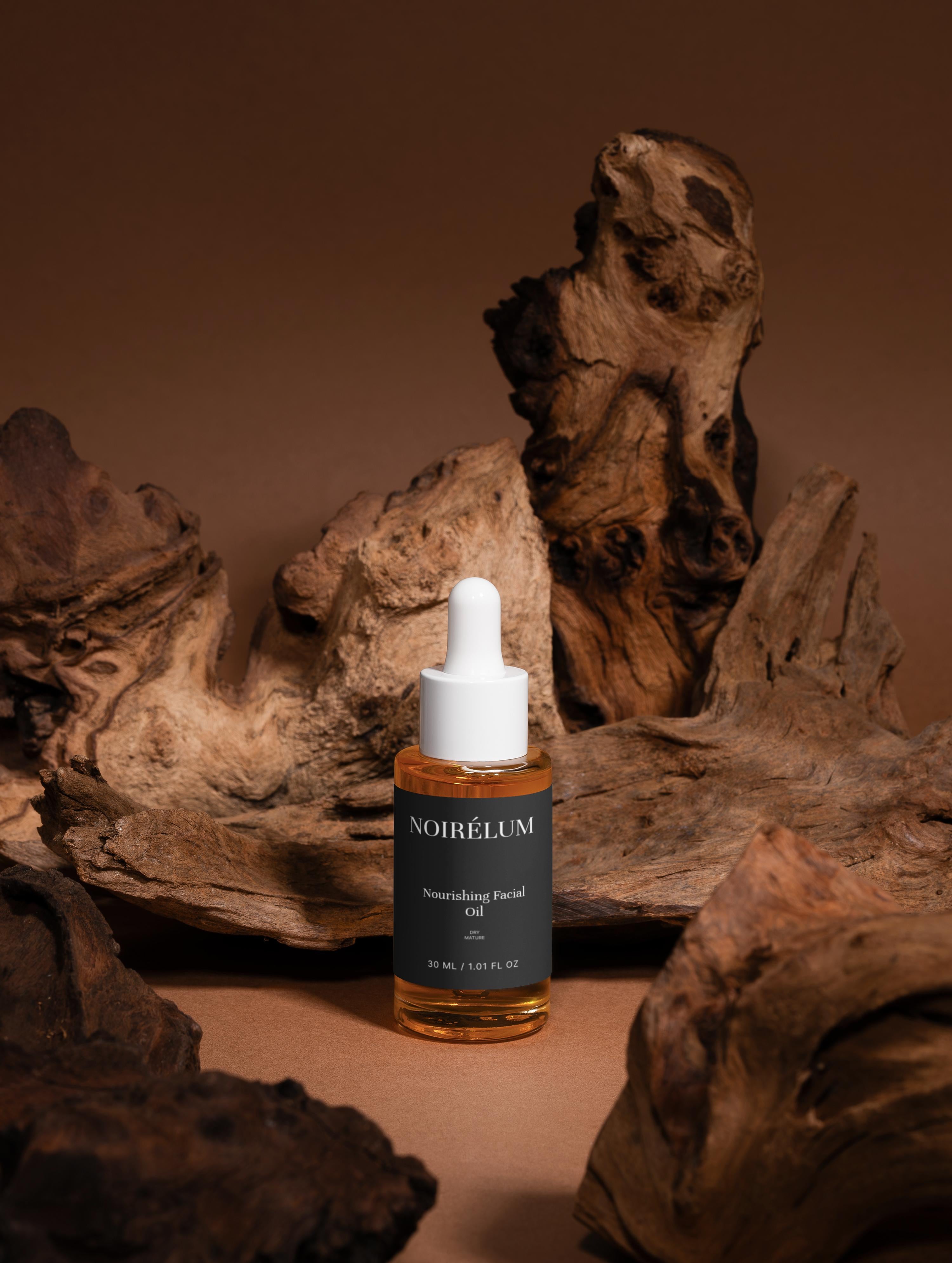 Noirelum Nourishing Facial Oil Bottle of All-In-One Facial Oil on a brown background with wooden textures