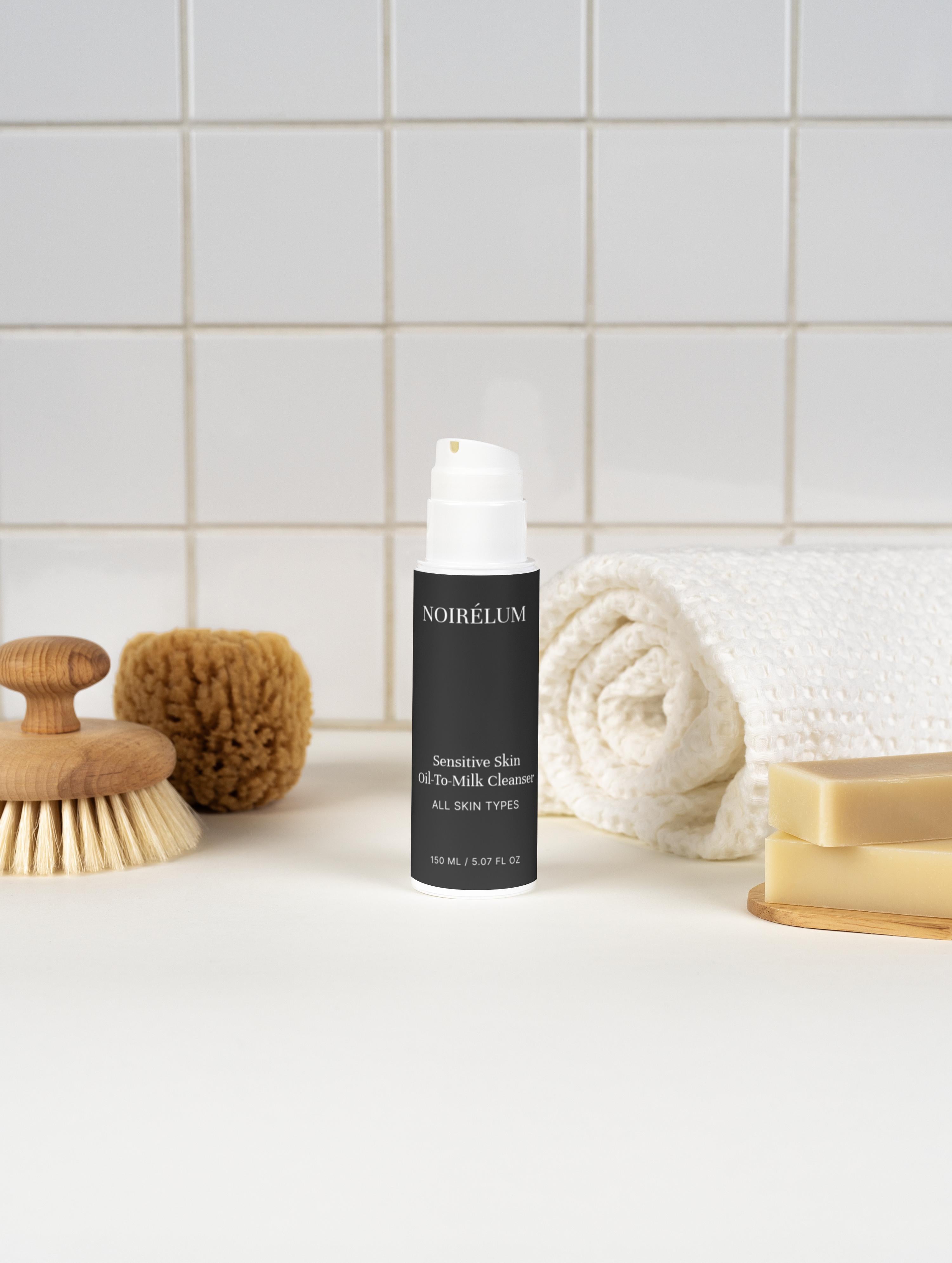 Noirelum skincare bottle on a bathroom counter with a towel and soap.